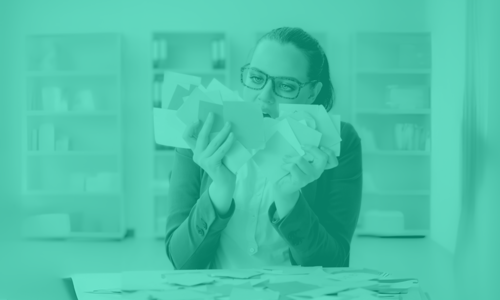 Girl with glasses holding lots of post-it notes trying to get organised but looking confused.